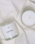 Scented coconut wax candle in glass vessel.