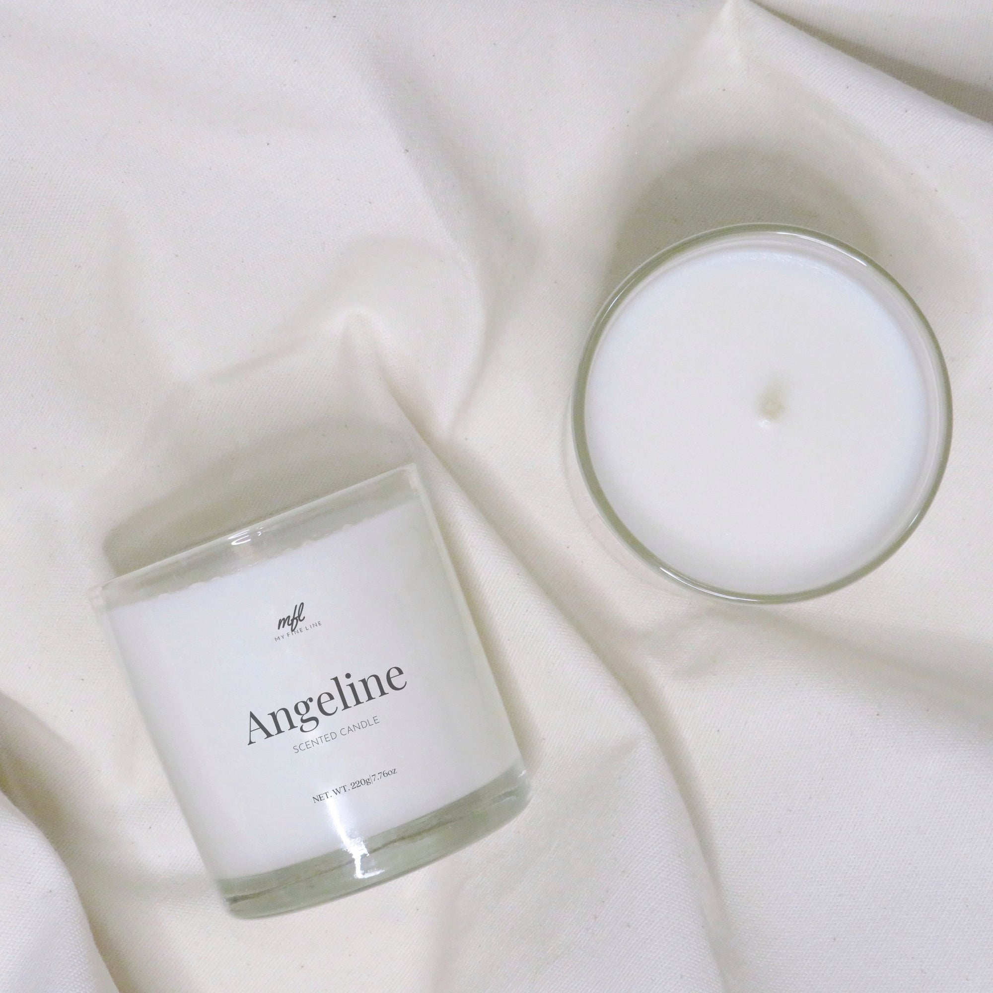 Scented coconut wax candle in glass vessel.