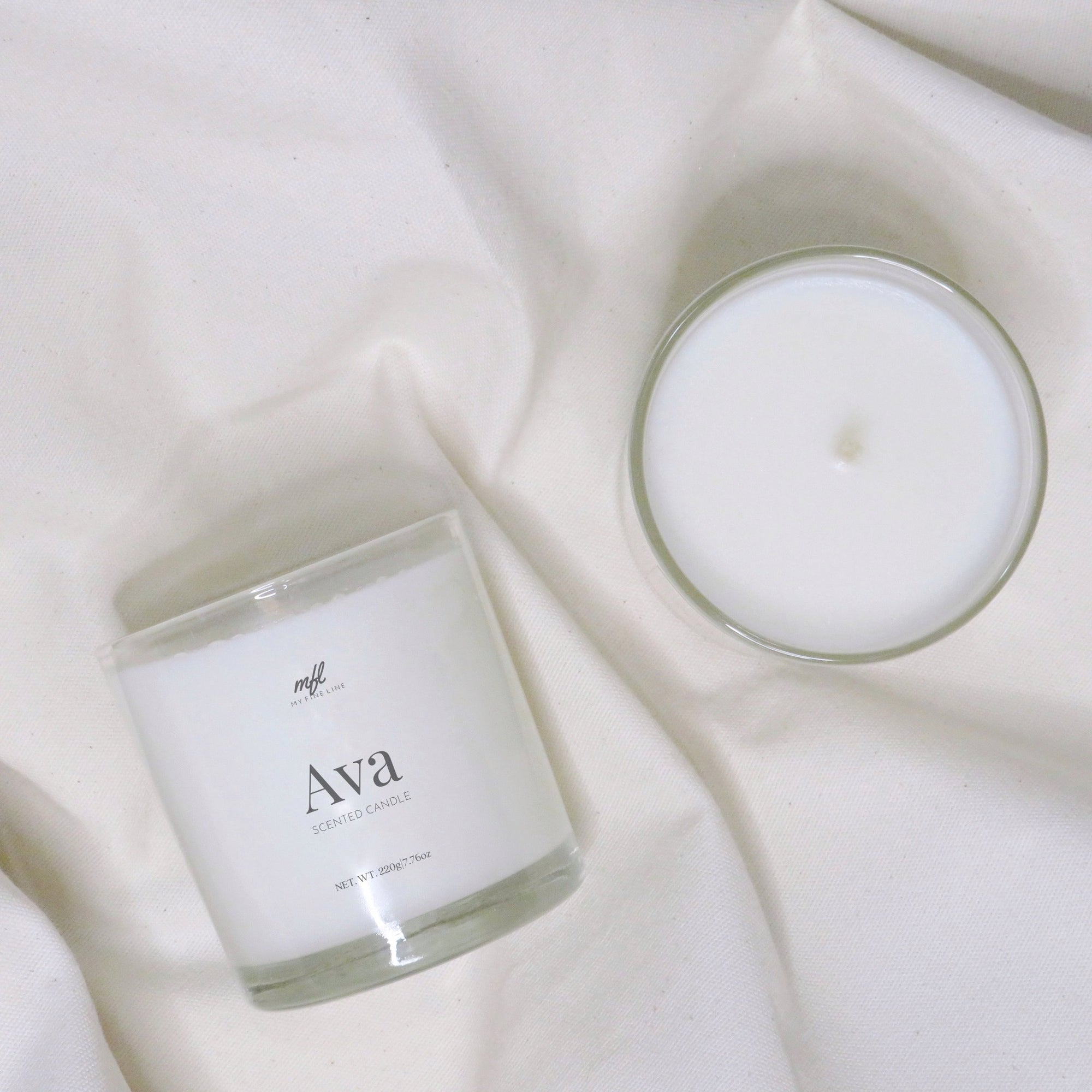 Scented coconut wax candle in glass vessel.