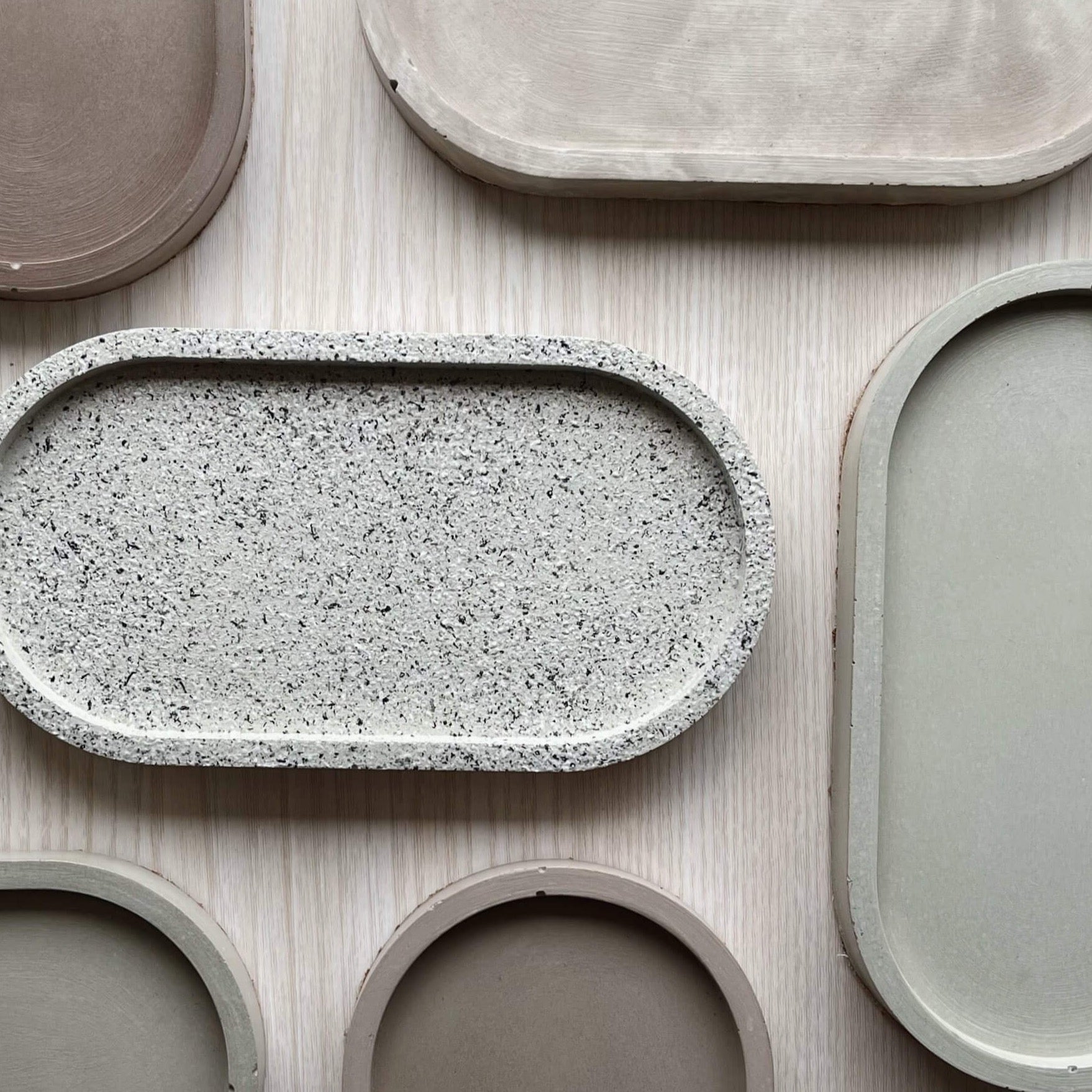 Concrete trinket trays in a range of colors and textures. 